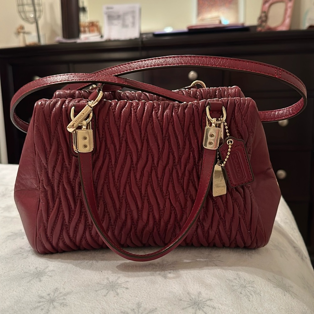 Coach purse. Burnt Red in color. No scratches. Used a couple of times.